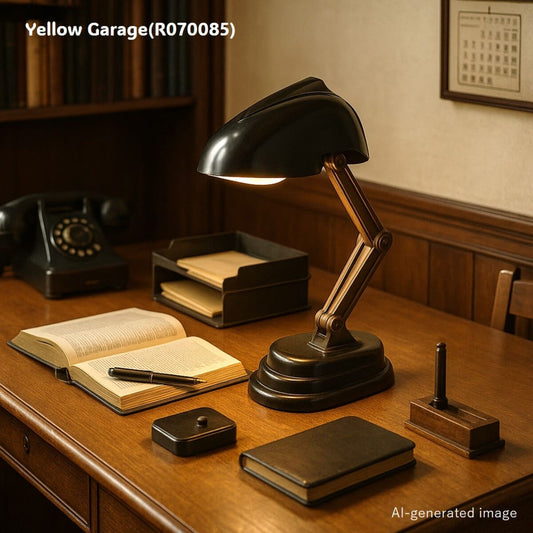 フランスの名門メーカー「JUMO（ジュモ）」による、希少なブラックカラーのヴィンテージデスクランプです。特徴的なクレーン構造のアームにより、シェード部分を自由に角度調整でき、ヘッドを閉じると内蔵された小型スイッチによって自動的に消灯するユニークな仕組みを備えています。