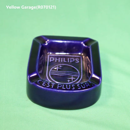 オランダの電機メーカーPHILIPS（フィリップス）のロゴとスローガン「C'EST PLUS SÛR（それはより安全）」が刻まれた深い青の美しい陶器製灰皿＿正面から